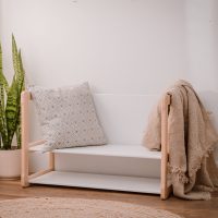 big bench with shelf in white in a setting