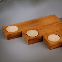 Wooden tealight holder set in TEAK laid out close up